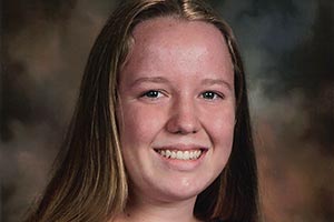 Young woman smiles for the camera.