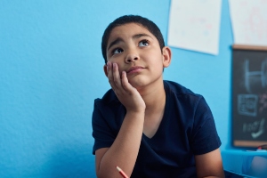 Distracted boy stares off into space