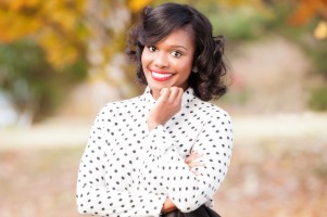 Logan Rena, woman smiling wearing white blouse with black polka dots